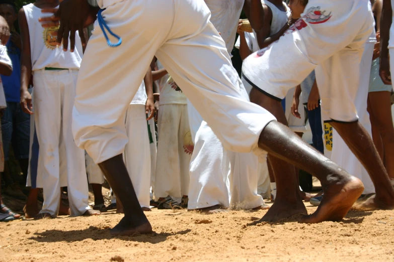 two men performing a trick while others watch