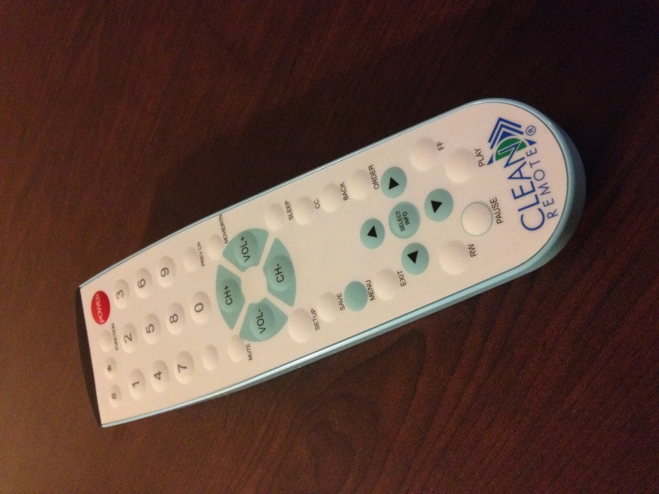 the remote control is on the table with a light blue stick