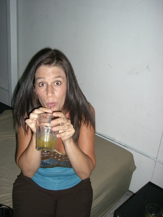 a woman with a glass and straw in her hand