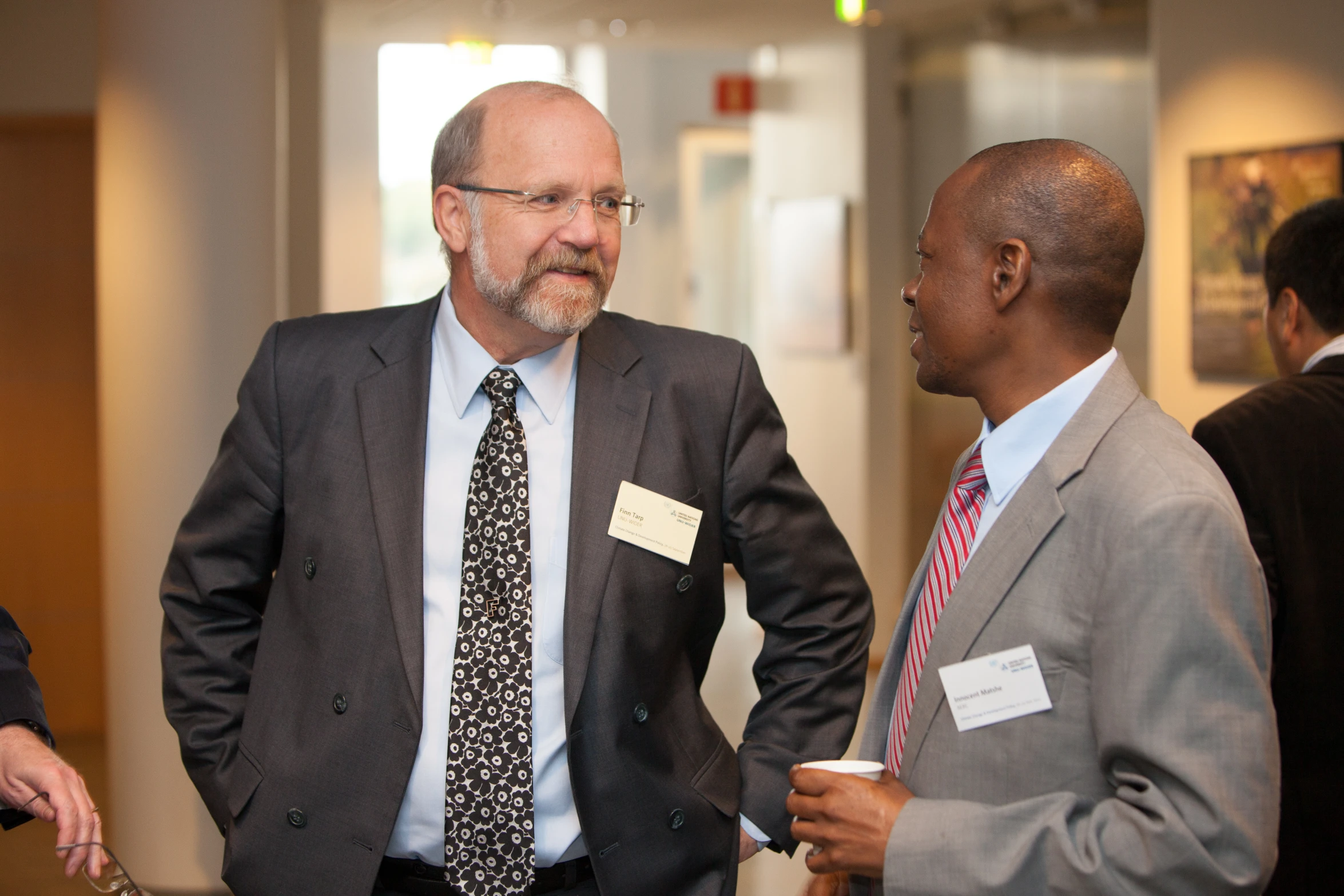 two men in business suits meet for a moment