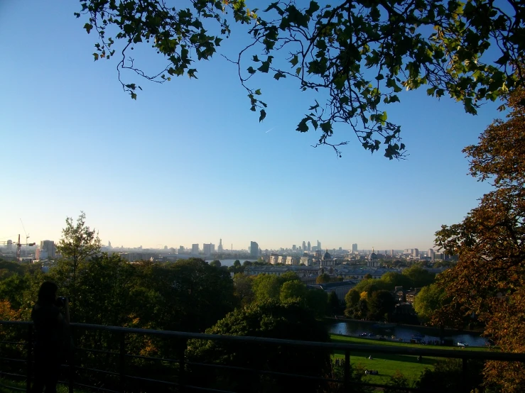 a view of a city, a lake and trees