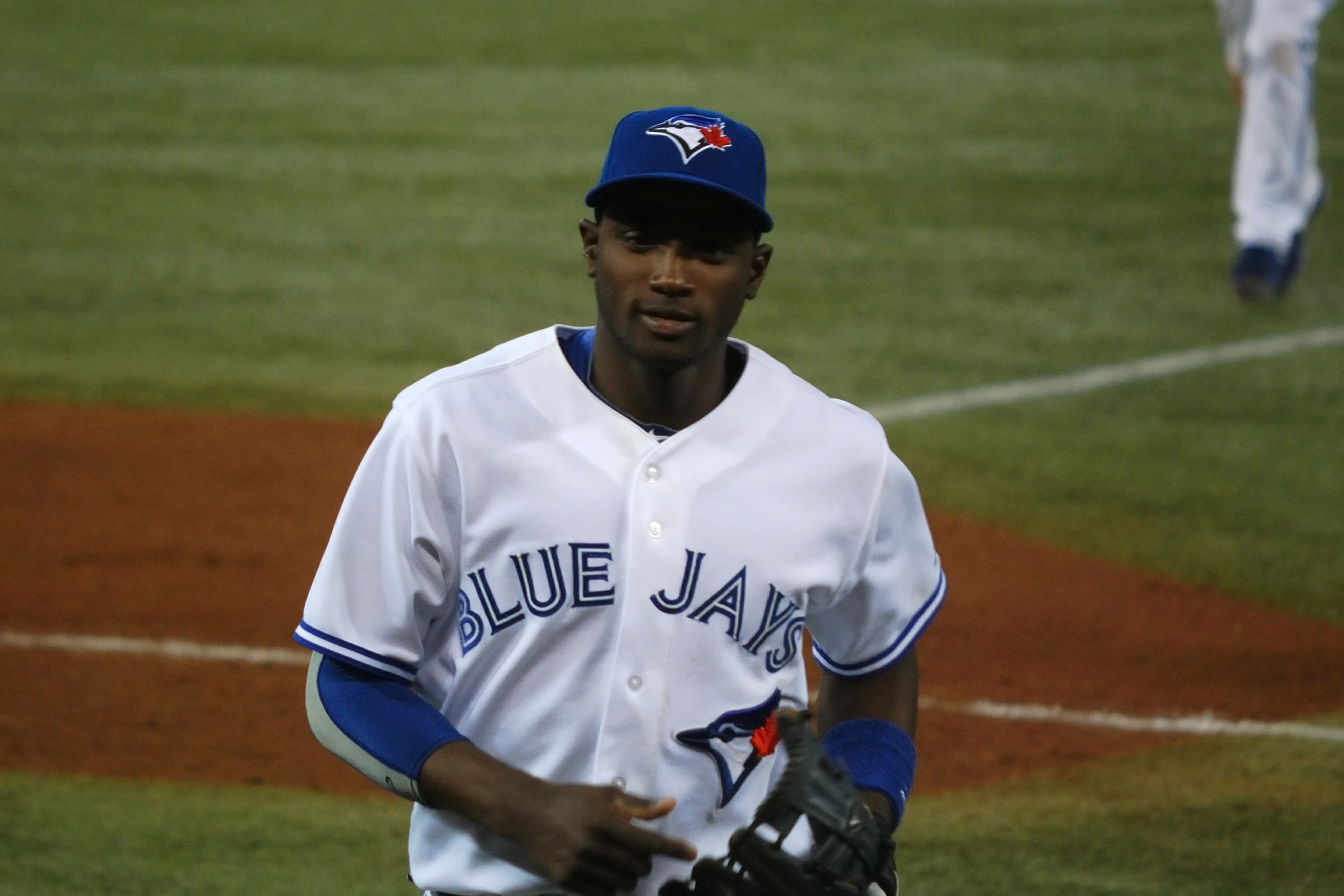 a baseball player on a field with his glove in hand