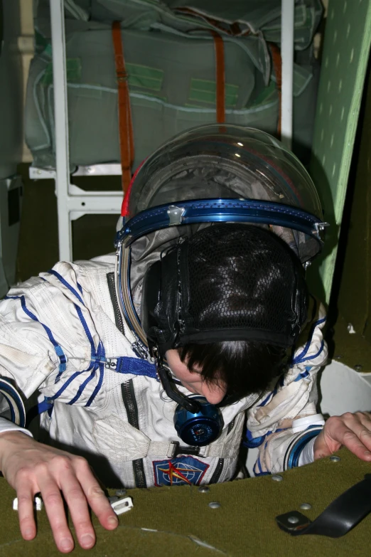 a man in space suit sitting in a chair