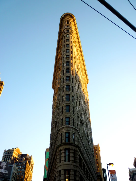 the flatiroal building sits in front of tall buildings