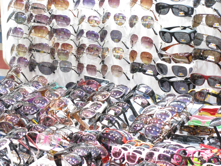 a display filled with lots of different types of sunglasses