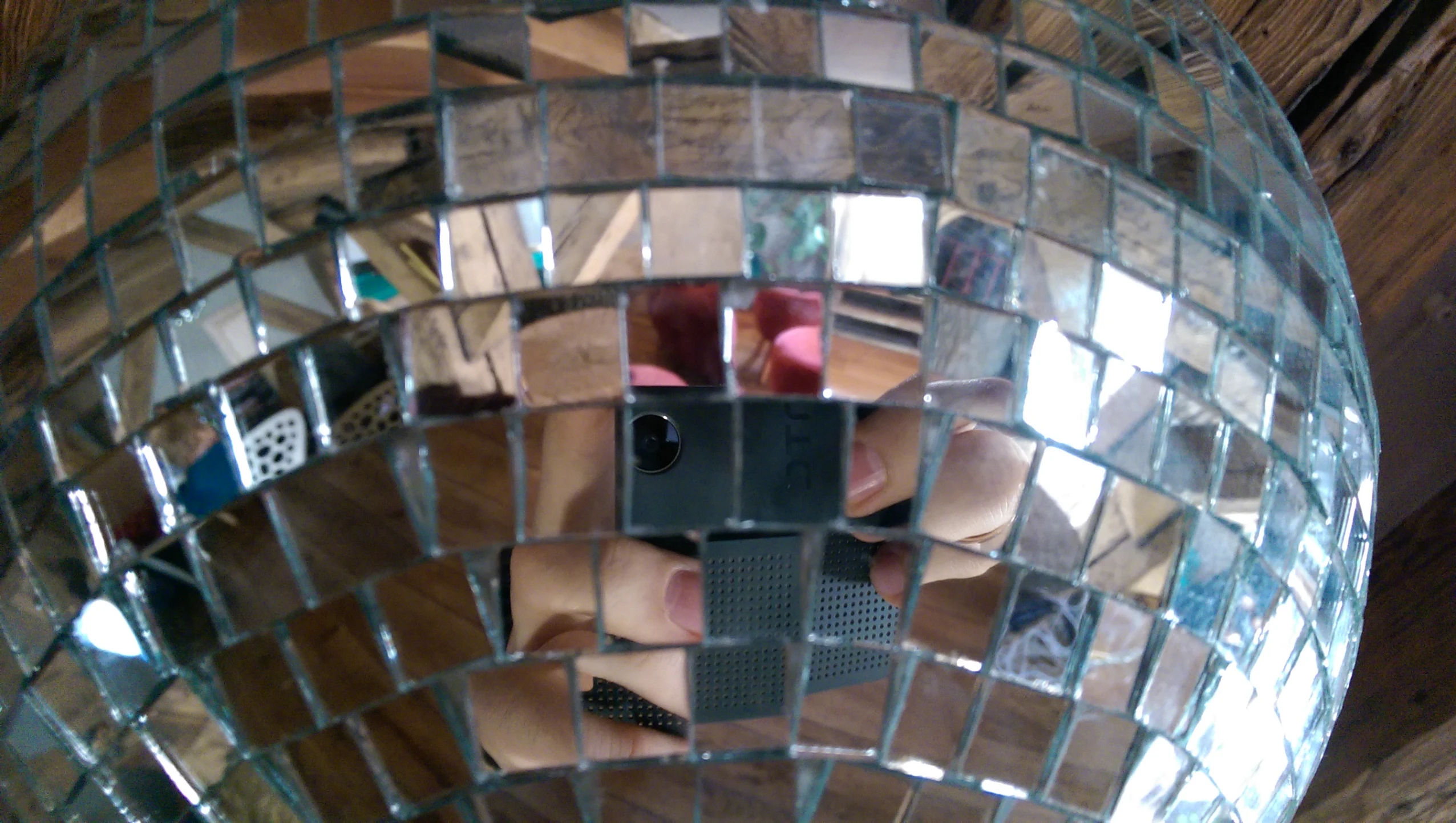 a person's reflection in a mirror that is shaped like cubes