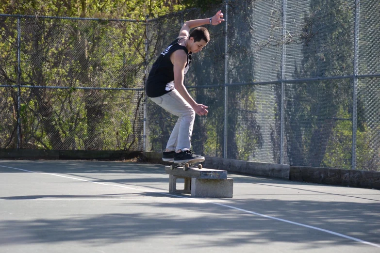 a man riding a skateboard down the side of a cement block