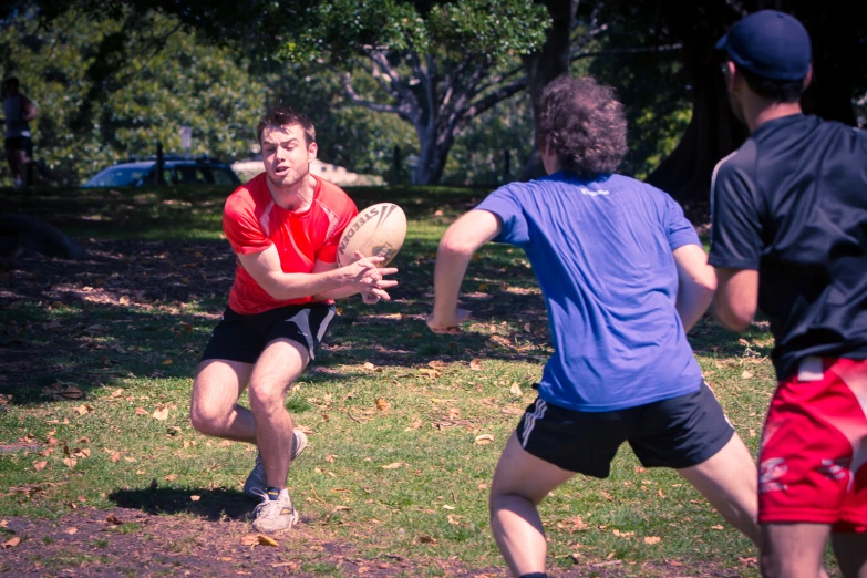 a man prepares to catch a frisbee while another plays on the ground