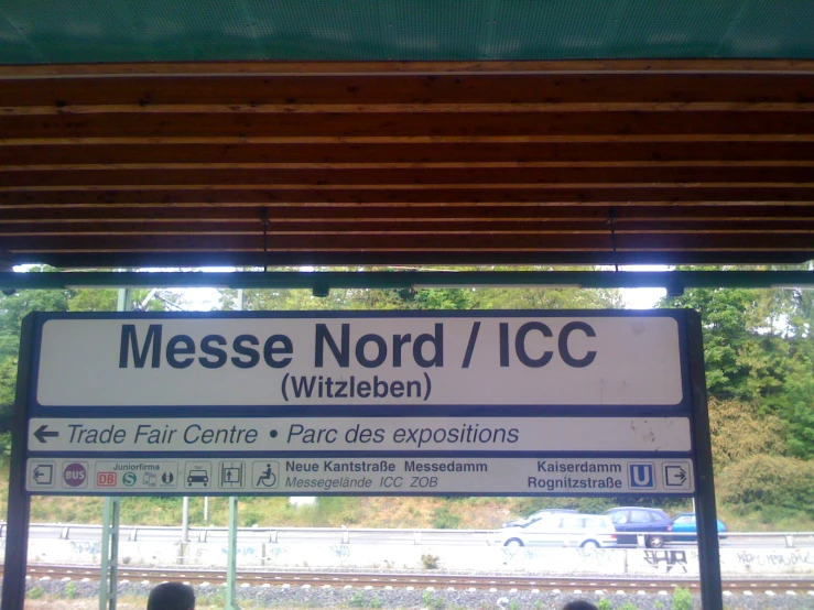 a sign that reads messe nord / icc wichelen at a train station