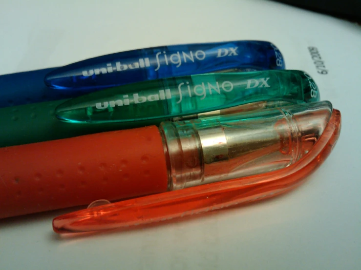 an image of three pens and a light that is on top of a table