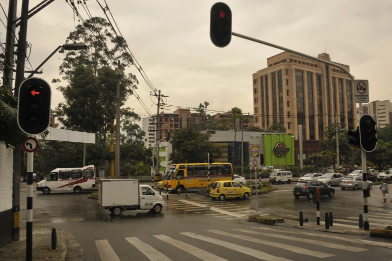 a city street filled with traffic and covered in rain