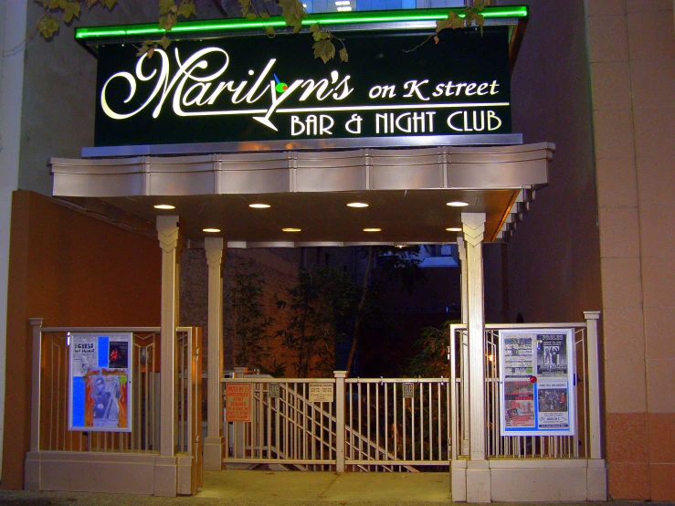 a sign for the outside of a bar with a light up lettering