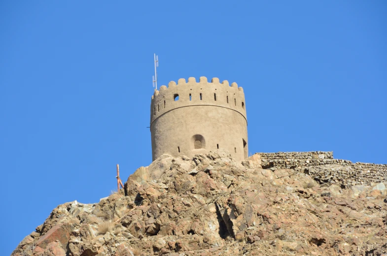 a very tall castle on top of a rocky hill