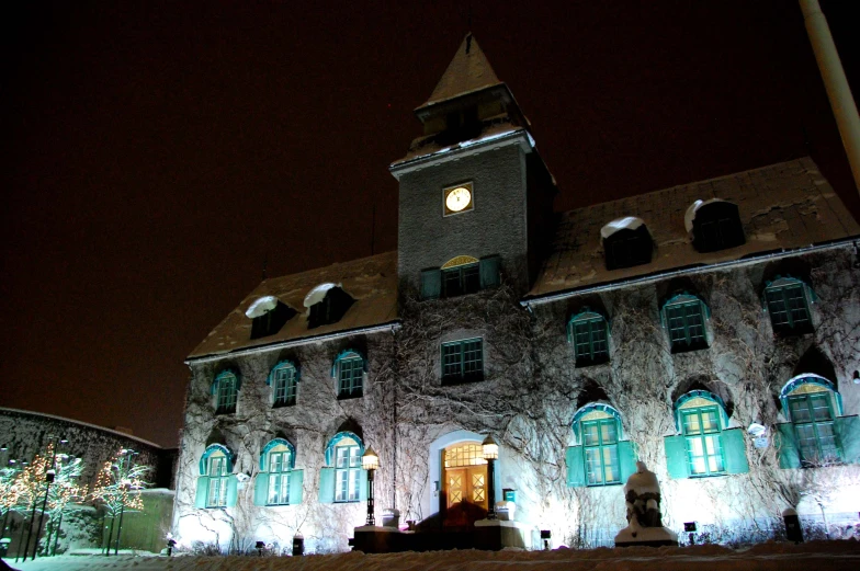 the building has a clock on it and two windows