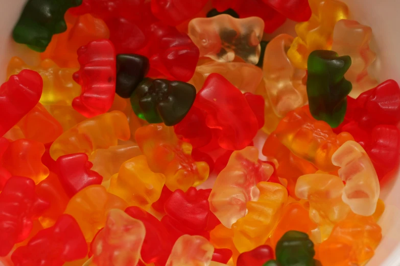 many gummy bears in a bowl of water