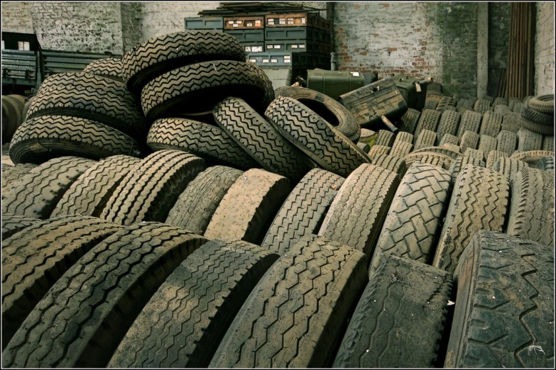 tires piled on top of each other near a building