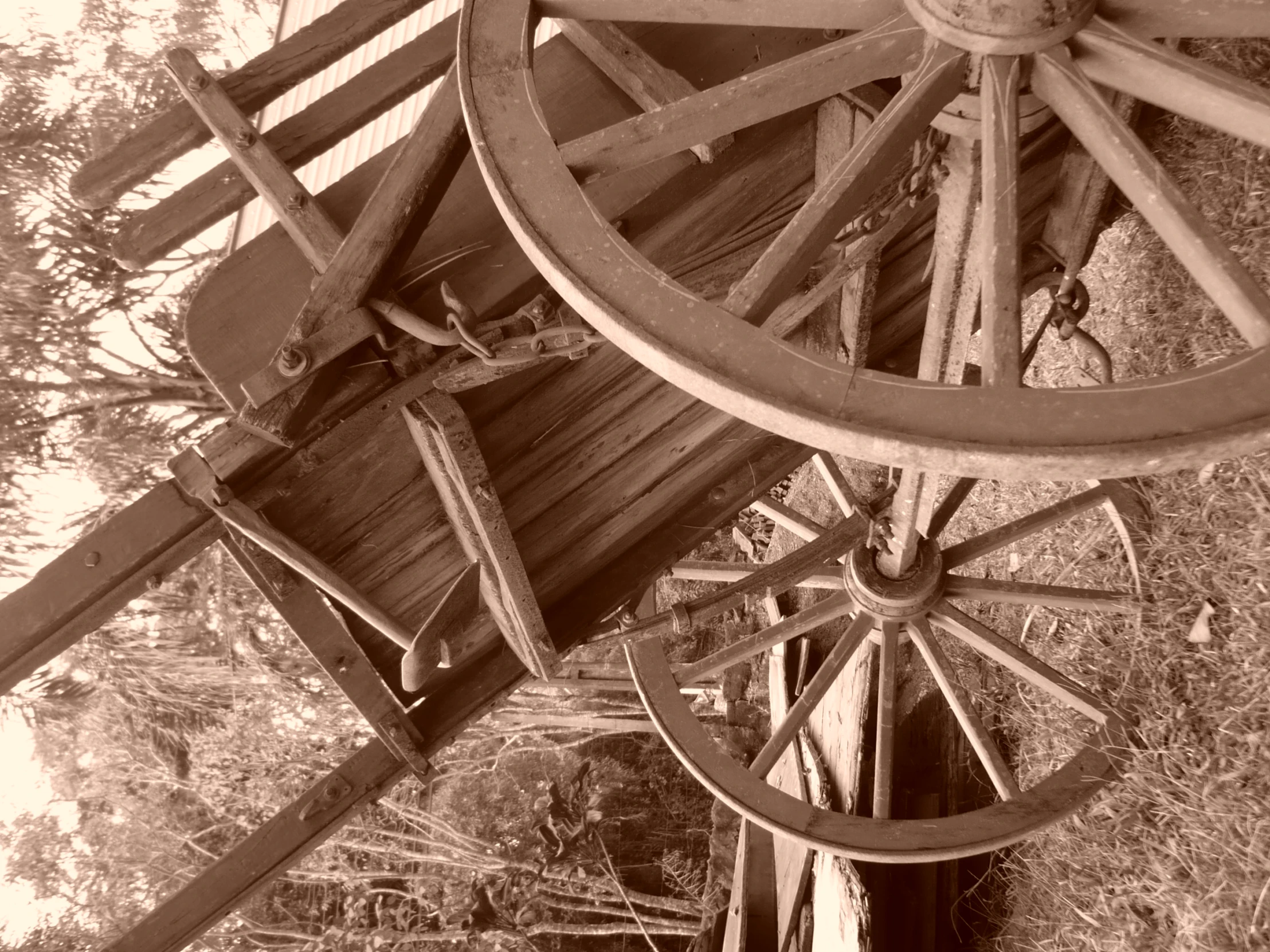 two old, wooden wheels sitting next to each other