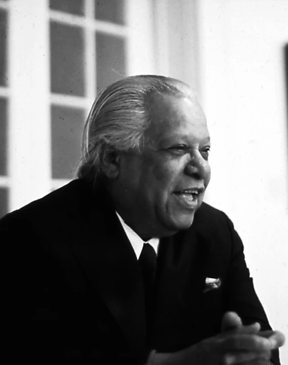 a black and white po of an older man in a suit