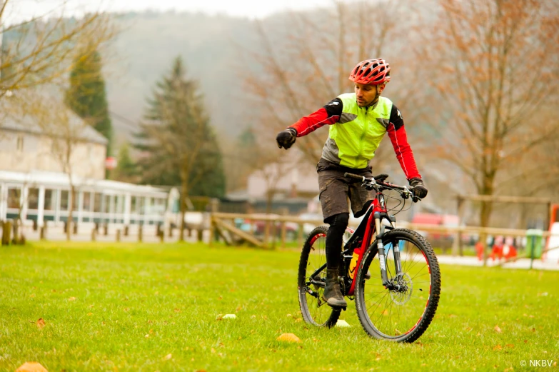 a man is riding a bike through a field