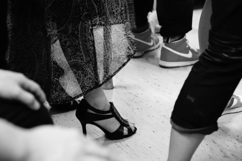 black and white pograph of people standing in a room