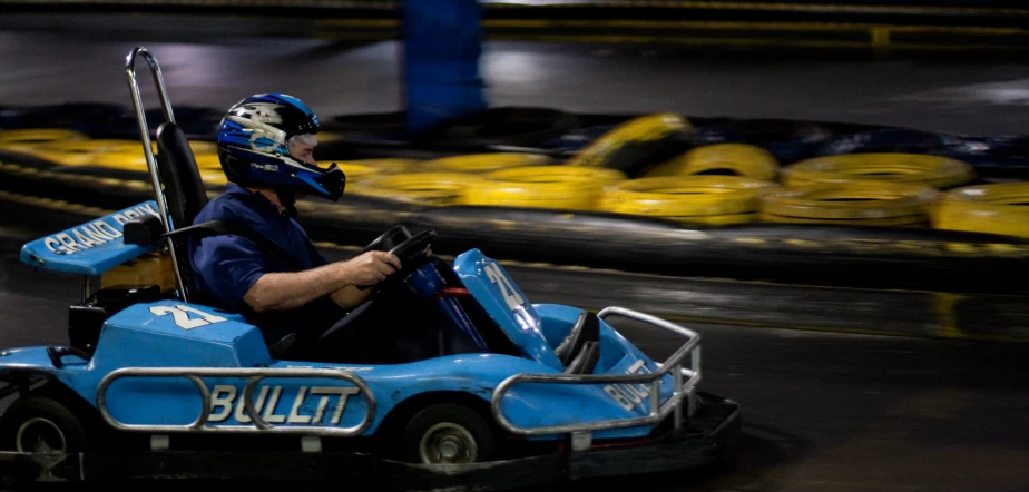 man riding in an amut vehicle with a gun