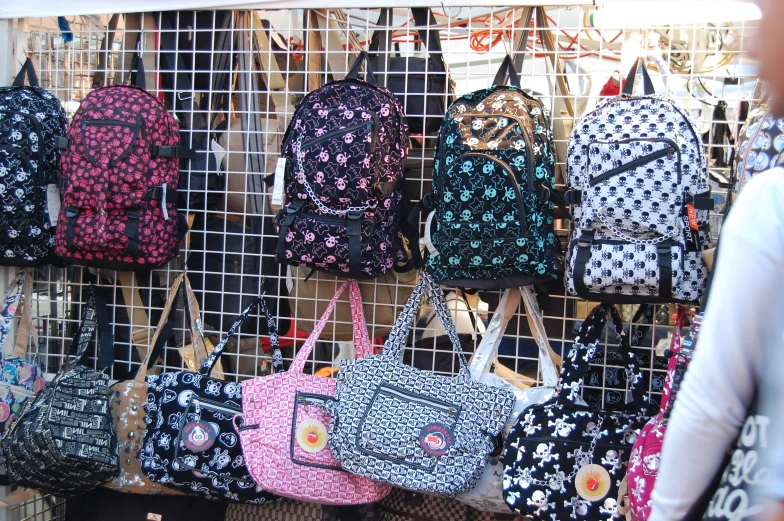 a wall filled with many different types of backpacks