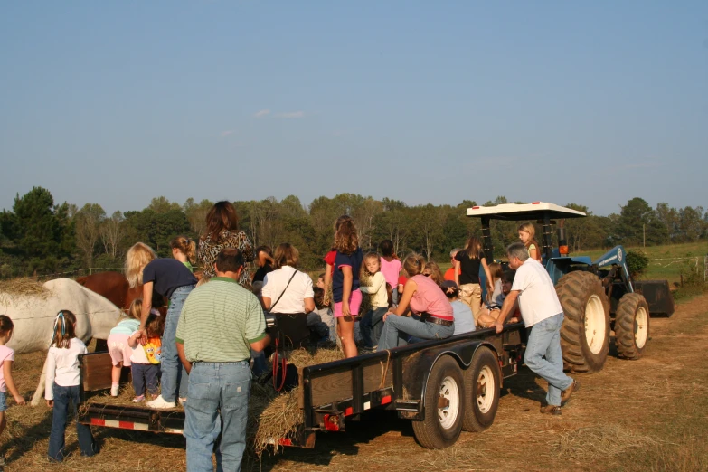 a couple of people are riding on top of a tractor