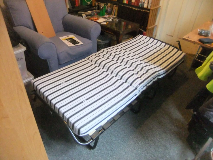 the black and white bed has a striped cover