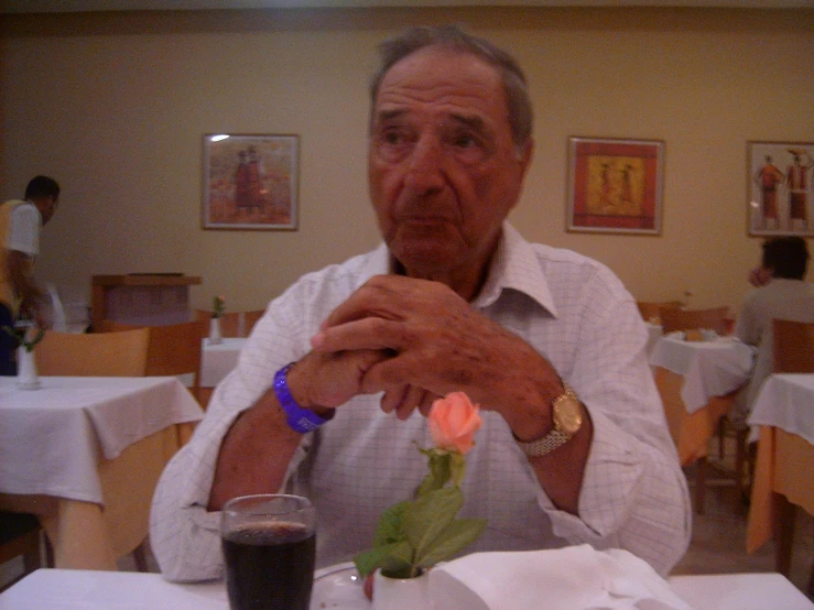 a man sitting at a table with food in front of him