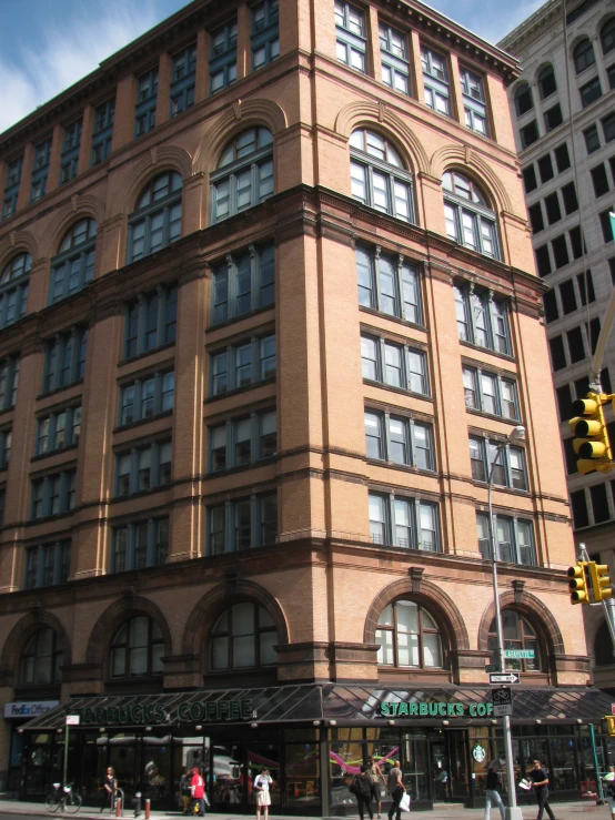 a tall building with lots of windows on the corner