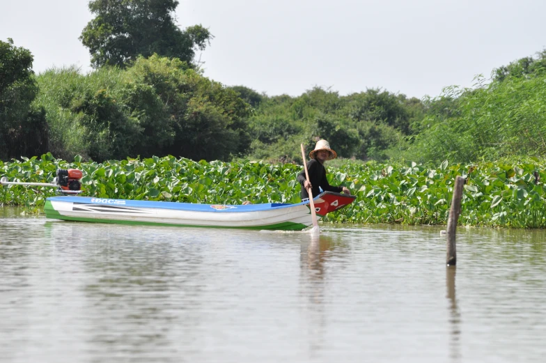 a young man paddling a boat on water