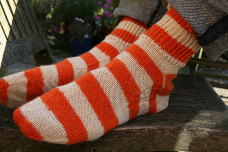 the red and white striped socks are worn over the jeans