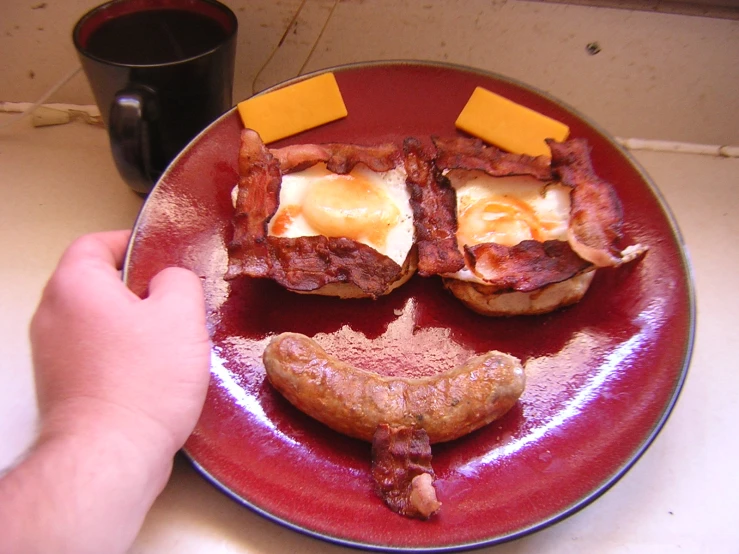 plate of food with bacon, eggs and cheese on it