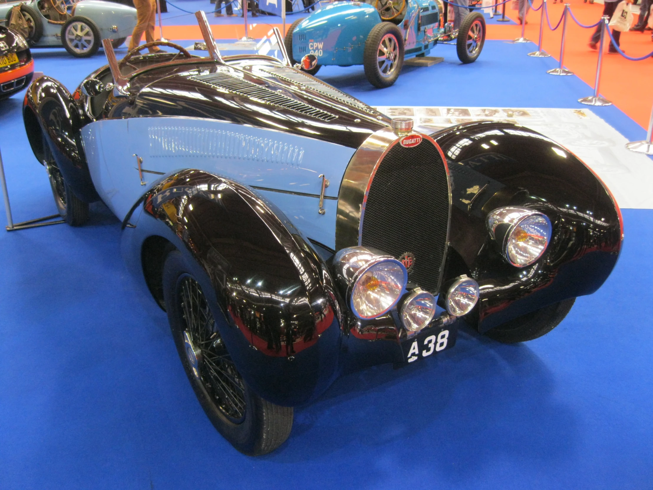 the front end of a classic car on display