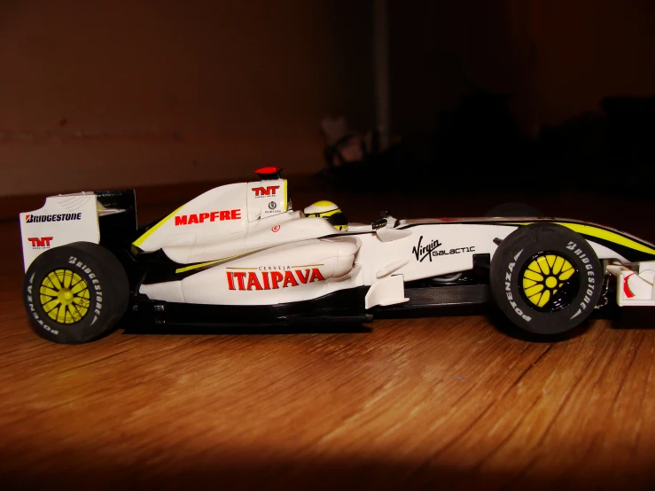 a toy car sits on top of a wooden table