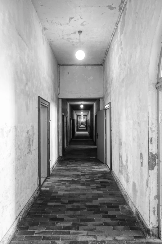 an empty corridor with windows and tile floors