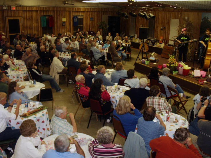 a large group of people are in a room