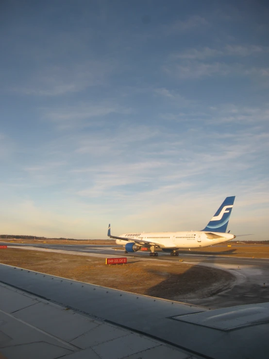 a white airplane sitting on top of an airport runway