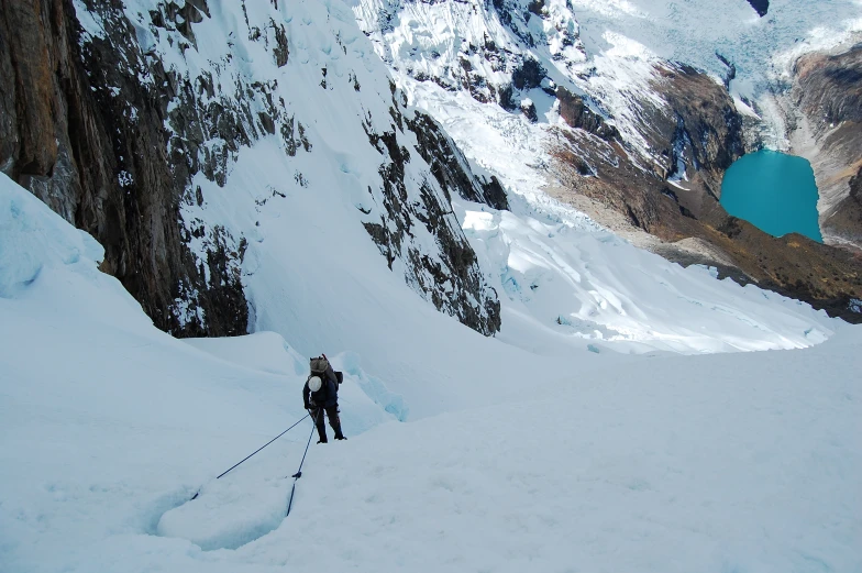 a man on skis walks in snow next to some mountains