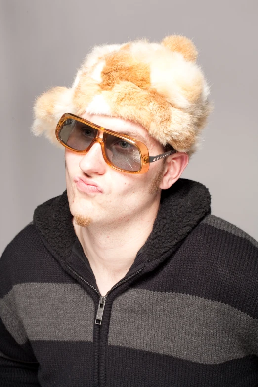 a man in shades and a fuzzy teddy bear hat
