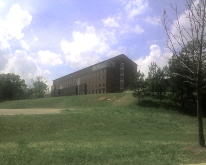 the grassy field with a small building at the top of it