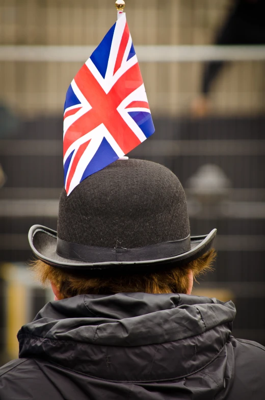 an older man with a union jack hat and grey jacket