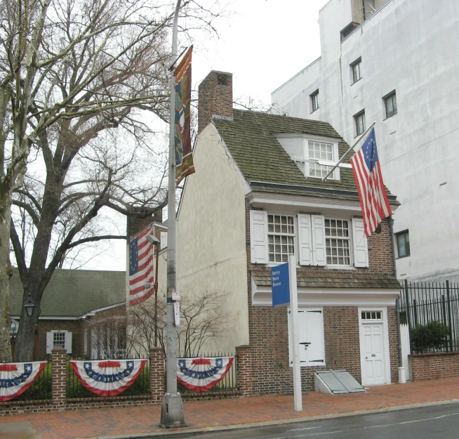 small house painted like the american flag and decor on a residential street