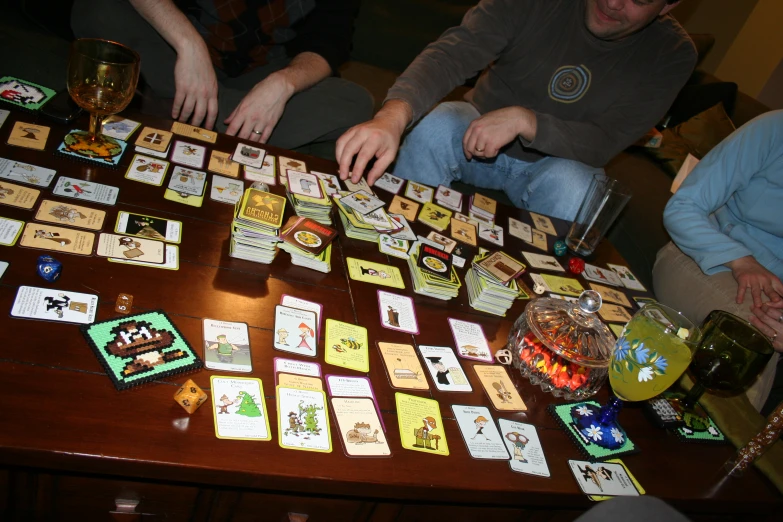 a number of people at a table with cards and drinks
