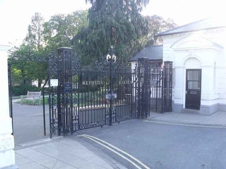 a gated driveway next to a building