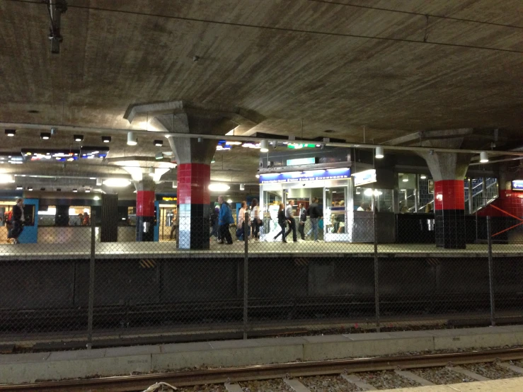 a subway train stopped at a crowded train station