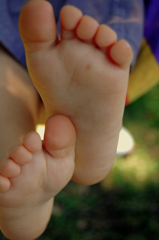 an open toe on someone's feet with grass behind them