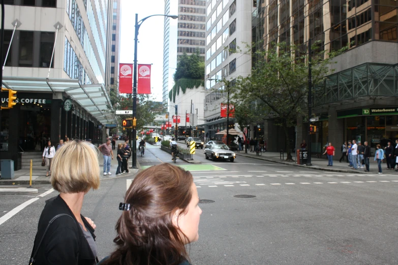 a crowded city intersection with pedestrians crossing the street