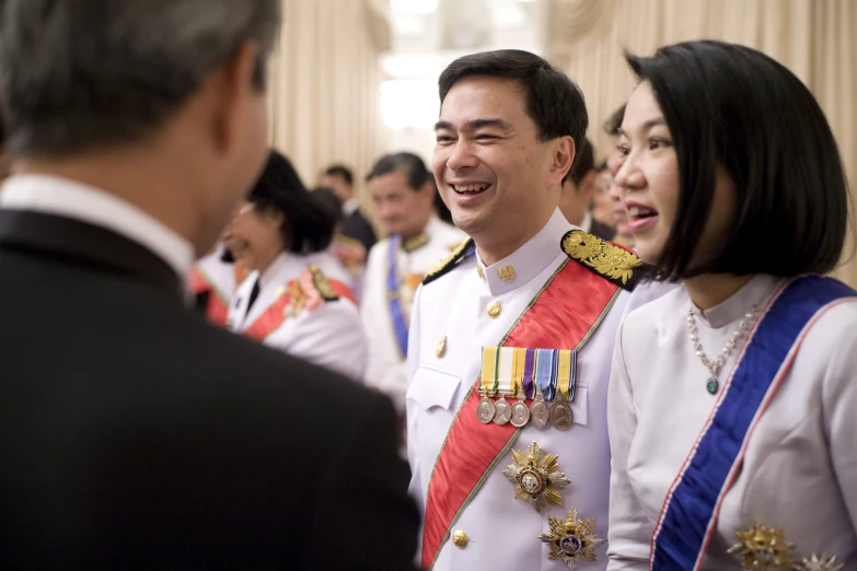 two women and a man are talking and smiling