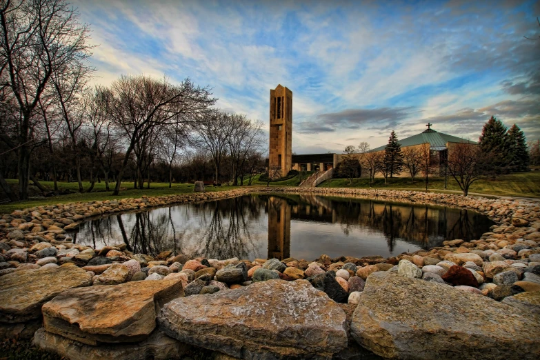 water and rocks surrounding the pond at an old building